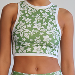 Green and white floral sports outfit on a plain background