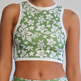 Green and white floral sports outfit on a plain background